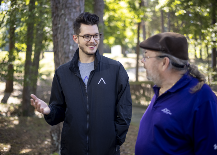two employees talking in nature