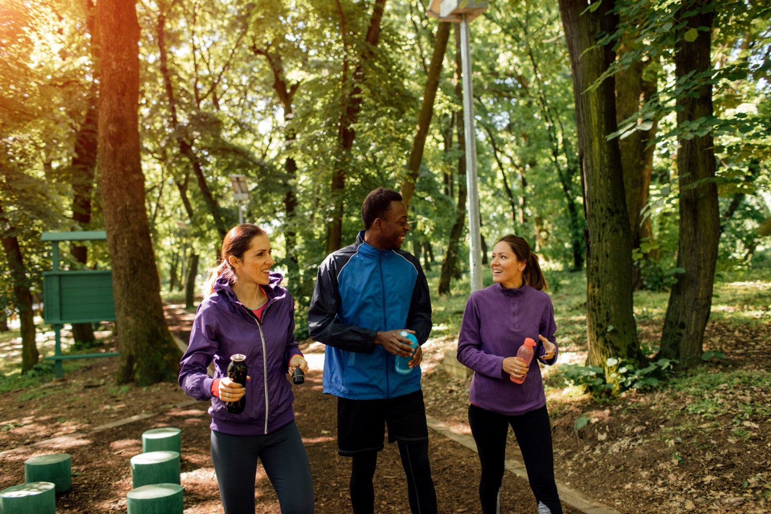 three employees in fitness apparel walking together