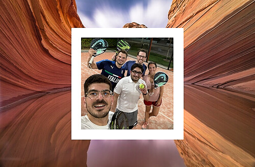 A group of five people posing for a selfie on a paddle tennis court. They are holding paddle tennis rackets and a ball, with one person wearing a shirt that reads "ITALIA." The group appears to be in good spirits. The photo is framed within an image of a winding sandstone canyon, reminiscent of Antelope Canyon, giving it a layered and artistic appearance.